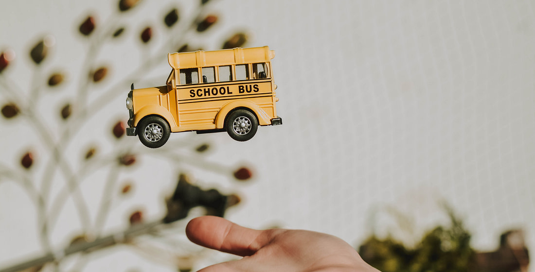 mini school bus toy thrown up from the hand